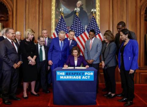 Speaker Pelosi signs legislation codifying marriage equality in 2022.