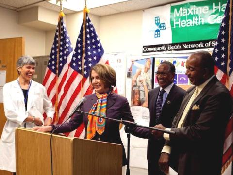 Congresswoman Pelosi standing behind a podium