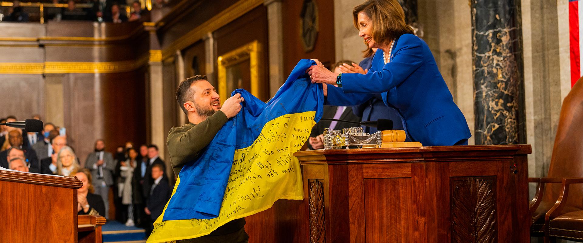 President Zelenskyy hands Speaker Pelosi a Ukrainian flag signed by Ukrainian soldiers