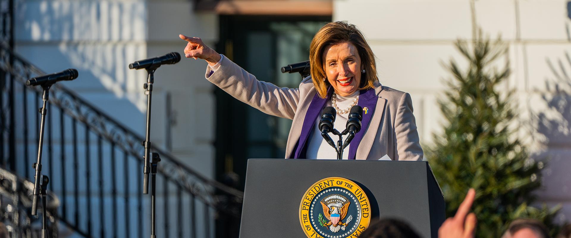 Speaker Pelosi points to the crowd during the Respect for Marriage Act bill signing